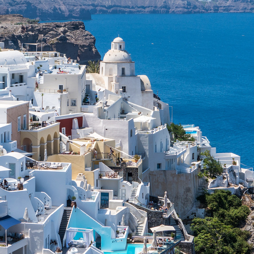 Ground-truth Santorini scene with a white building among rocks